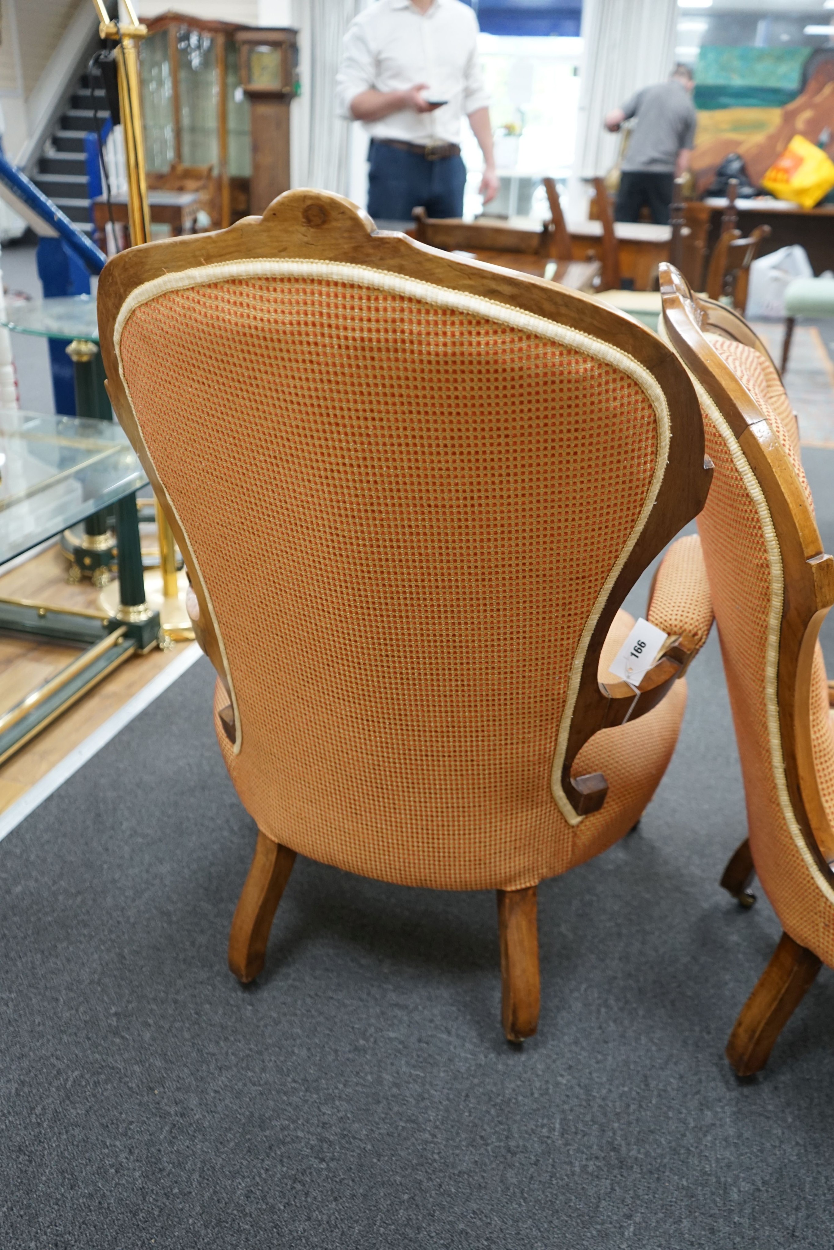 A pair of late Victorian walnut spoon back chairs, one with arms, larger width 68cm, depth 60cm, height 100cm